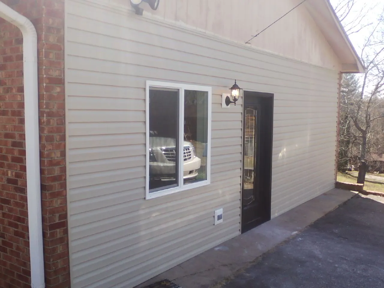 New vinyl siding and entry door on a room addition in South El Monte